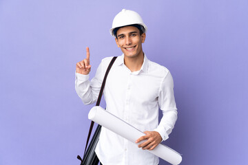 Young architect man isolated on background pointing up a great idea