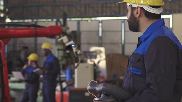 Team of Robotics engineer control automation robot arms machine in factory industrial for Production Line using system software support operator Industrial.