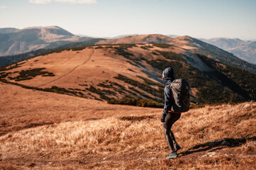 Traveler hiking  with backpacks. Hiking in mountains. Sunny landscape. Tourist traveler on...