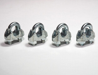 Wire rope clamps to secure wire ropes. Wire rope clips on white background. Tension cable assembly...