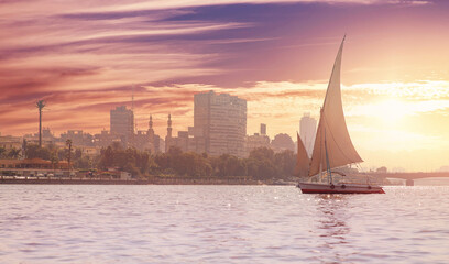 Sunset river Nile white yacht background skyline of Cairo, Egypt