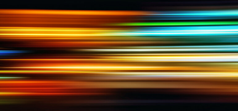 Abstract Rainbow light trails on the dark blue background
