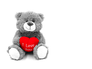 Gray teddy bear with red heart and text I love you. Teddy bear for Valentine's Day.