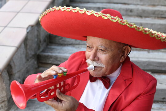 Traditional senior Mexican man playing the trumpet