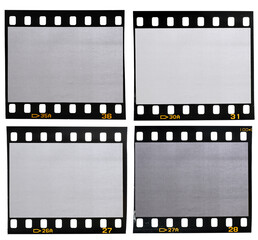 four different 35mm film strips with blank or empty frames on white background. vintage photo...