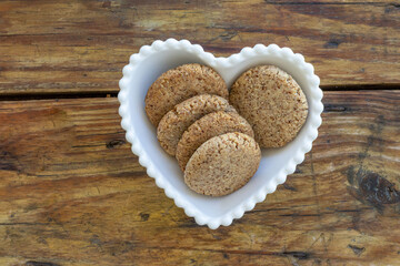 Homemade almond vegan cookies - in heart-shaped bowl