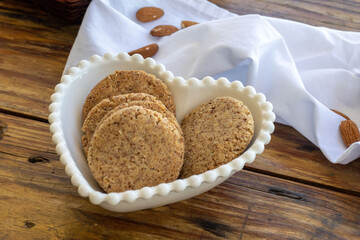 Homemade almond vegan cookies - in heart-shaped bowl