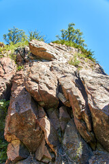 Fototapeta premium rocky cliff with cracks with trees on the top