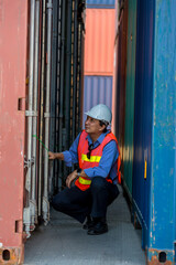 Professional foreman work at Container cargo site check up goods in container. Workers are opening containers for inspection and check.