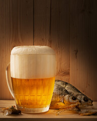 a mug of light beer with dried fish