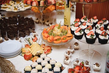 various dessert with fresh fruit on buffet line, sweet