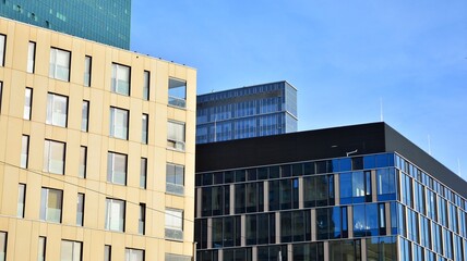 Fototapeta premium View of an modern apartment building standing next to a new modern office building with a glass facade.