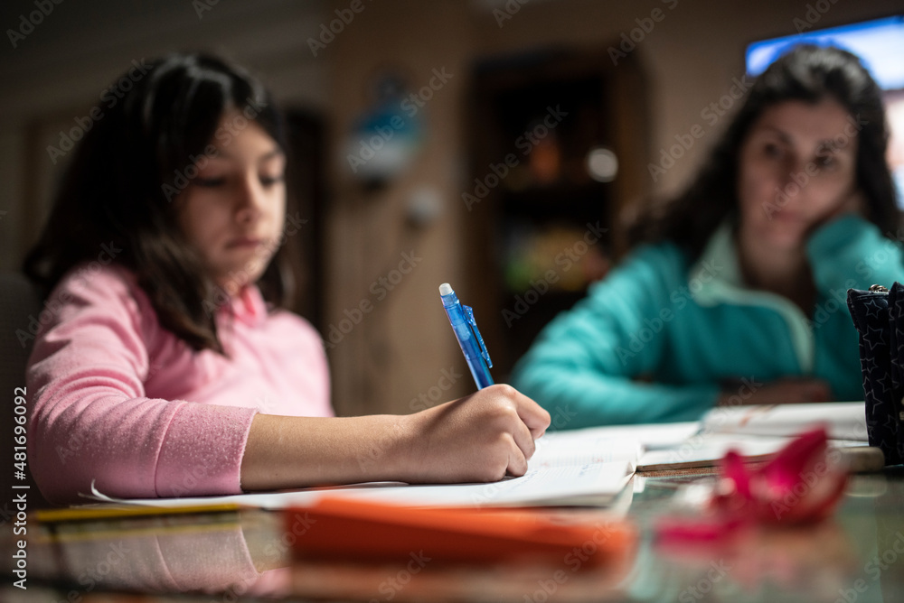 Wall mural mother helps daughter to do homework, real people in tracksuits in the garage at home