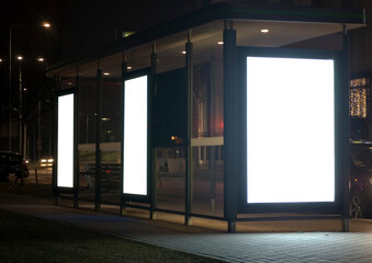Outdoor advertising billboard at nighttime in the city.
