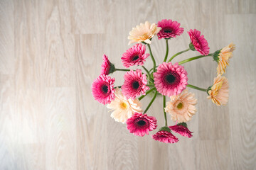 bouquet of Gerbera flowers on a wooden background with negative space
