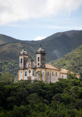 Fototapeta na wymiar View of the Church of São Francisco de Paula, with mountains in the background. Historic city of Ouro Preto, Minas Gerais. Portuguese colonial village, capital of Brazil in the Golden Age.