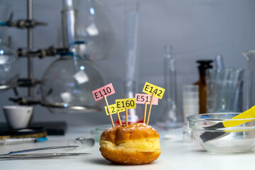 In the lab, a donut adorned with supplement name plates E. Food Laboratory.