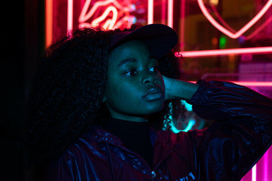 beautiful sexy girl with long dreadlocks posing in neon light