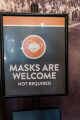 Sign for Masks are Welcome Not Required, at an indoor venue during the COVID-19 pandemic