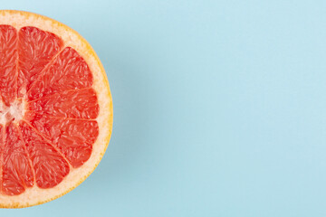 Grapefruit on blue background, top view, flat lay
