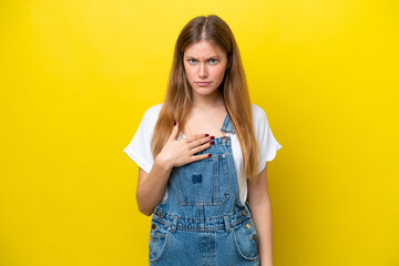 Young caucasian woman isolated on yellow background pointing to oneself