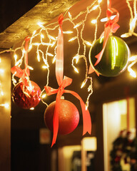 Ornaments and Christmas lights hanging from wooden beam