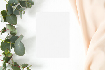 Stationery paper mockup with eucalyptus leaves