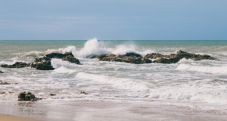 Water crashing onto rocks at the beach in california