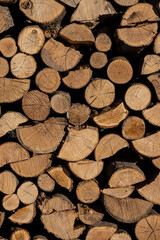 Pile of stacked triangle firewood prepared for fireplace and boiler