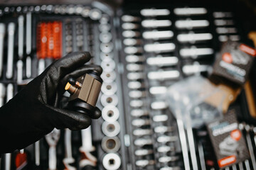Naklejka premium new drum brake cylinder in the hand of an auto mechanic