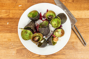 Avocado and onion leftovers on a plate after making a delicious guacamole.