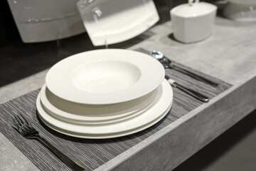 elegant luxury tableware is sold in the supermarket. Beautiful table setting on grey background