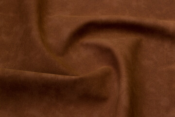 brown artificial leather with waves and folds on PVC base