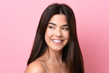 Young Brazilian woman isolated on pink background . Portrait