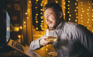 Loneliness man in self isolation video conference online on laptop. Concept alcoholism quarantine for coronavirus, pain death of lover people.