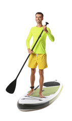 Handsome young man with board for sup surfing and oar on white background