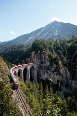Red Train in Switzerland. Train in Swiss Alps, Graub&uuml;nden.