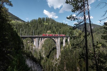 Red Train in Switzerland. Train in Swiss Alps, Graub&uuml;nden.