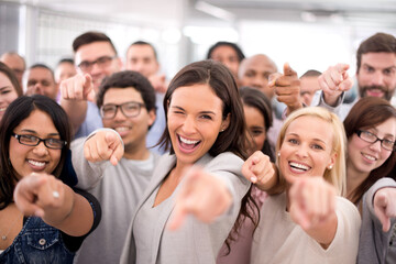 We want you on our team. Shot of a group of smiling businesspeople pointing at the camera.