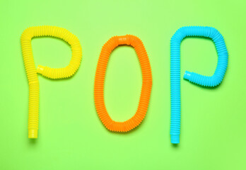 Composition with Pop Tubes on green background