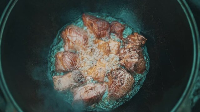 Step by step cooking of Pilaf in cauldron on fire.