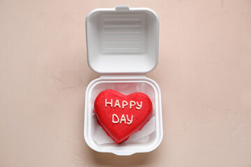 Plastic lunch box with tasty bento cake on beige background