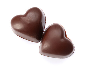 Tasty heart-shaped candies on white background