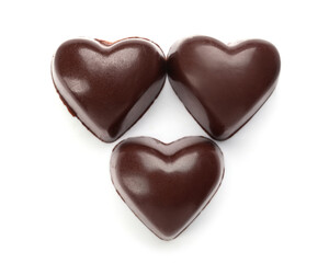 Tasty heart-shaped candies on white background