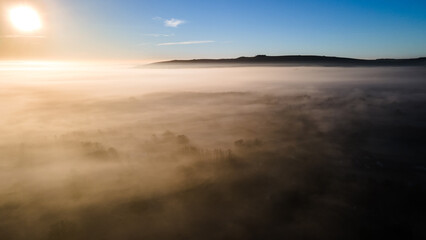 Fototapeta na wymiar Aerial picture of foggy morning over the park, forest, West Sussex, UK