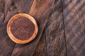 Brown mustard seeds in the bowl - healthy food