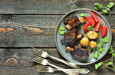 short ribs stew with new potatoes.
long stewed meat. serving with tomatoes and herbs