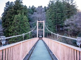 empty suspension bridge with red fences on sagami lake in kanagawa