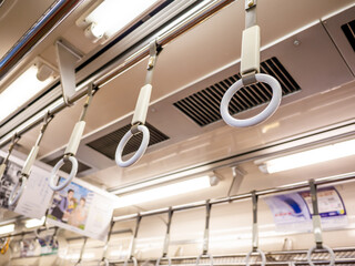 white hanging straps of the train in tokyo