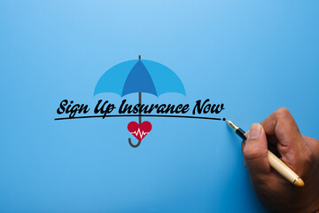 A picture of sign up insurance now with hand, pen, umbrella and heart. Apply insurance concept.